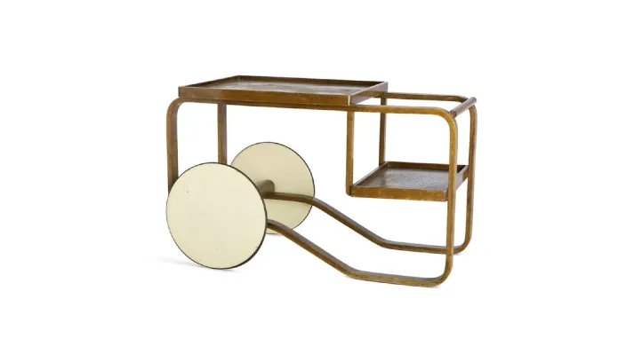 Alvar Aalto's 100/900 Tea Trolley (1937), a modernist serving cart with a bentwood frame, large disc wheels, and a dual-level design, originally designed for the 1937 Paris World’s Fair.